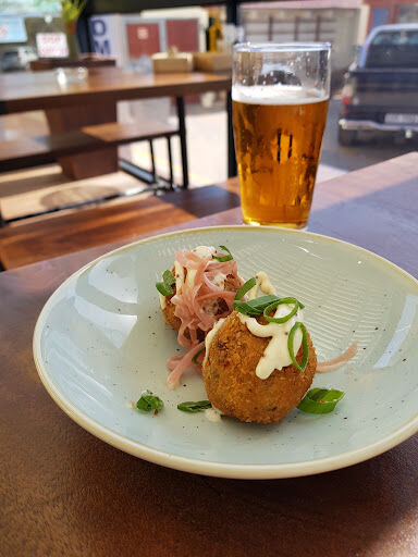 A cold beer next to a plated starter